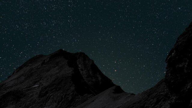a movement of stars in the night sky with the view of mountains