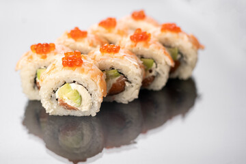 Sushi rolls on white background with reflection, space for text. Japanese food