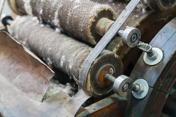 Nuts, gears and rollers of a wool carding machine.