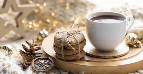Winter composition with a cup of cocoa and marshmallows on a blurred background.
