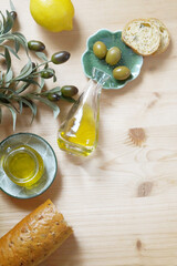 Extra Virgin Olive oil and olive fruit olive branch on the table