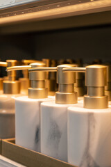 Containers for liquid soap or shampoo with a dispenser is sold in a supermarket.