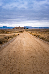 A road in the middle of the desert on a cloudy autumn day.