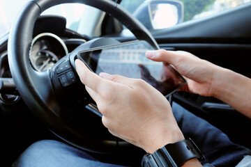 busines man Sitting in the Car and Using digital tablet.