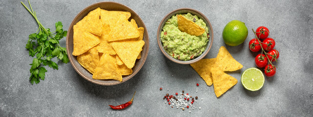 Mexican food guacamole with nachos, gray concrete background, banner. Top view, flat lay