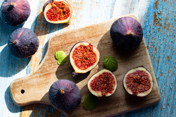 Fresh figs on cutting board. on a blue background, wooden. healthy food