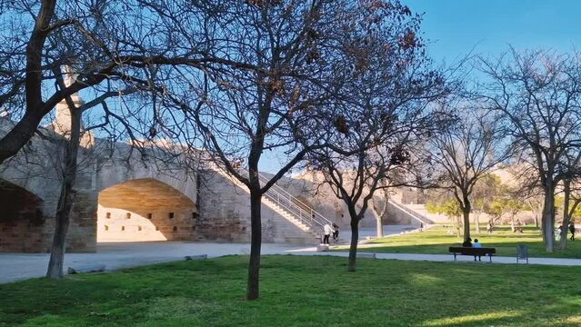 A walk through Turia Park in Valencia. A popular place for city residents and tourists for active recreation. Jogging and cycling paths under the bridge arch.