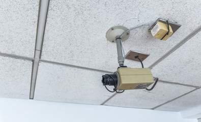 modern security camera mounted on a building, symbolizing surveillance and protection, with a sleek...