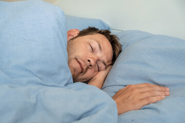Handsome caucasian man sleeping in bed in the morning rest for healthy wellness in bedroom at home....