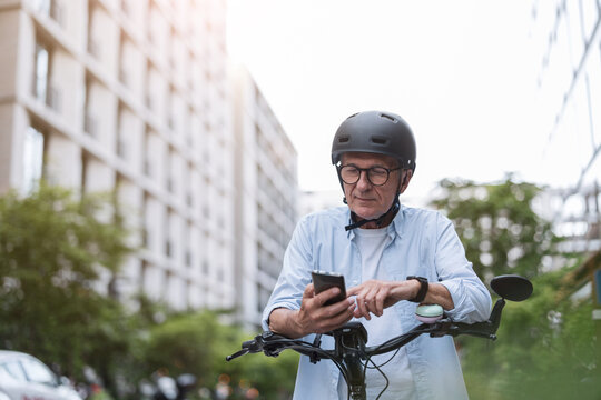 Mature man using mobile phone while riding bicycle in the city
- Powered by Adobe