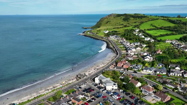 Aerial video of Ballygally Head Beach and Village on the County Antrim Coast road in Northern Ireland