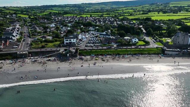 Aerial video of Ballygally Head Beach and Village on the County Antrim Coast road in Northern Ireland