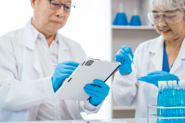 Senior scientists analyzing pharmaceuticals, asian people, senior man and woman, experienced...