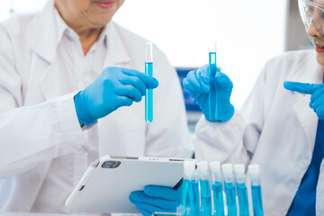Senior scientists analyzing pharmaceuticals, asian people, senior man and woman, experienced...