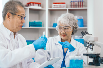Senior scientists analyzing pharmaceuticals, asian people, senior man and woman, experienced...