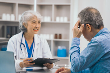 Elderly patient asian people attentively listening to mature doctor, receiving valuable health advice and discussing comprehensive health results in caring medical environment. Health Consultation