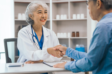 Fototapeta premium Asian people mature dentist having a compassionate conversation with elderly patient, discussing oral health results, providing expert advice and detailed dental report. Dental Guidance