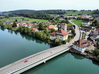 Fototapeta na wymiar View of the Aare bridge and Aarwangen village with a castle, canton of Bern, Switzerland. Aerial view