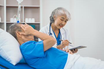 Senior elderly male patient and asian people mature woman doctor, showcasing importance of healthcare expertise and patient support. caring senior doctor assisting elderly patient in hospital bed