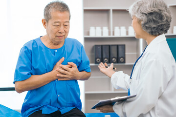 Obraz premium Senior elderly male patient and asian people mature woman doctor, showcasing importance of healthcare expertise and patient support. caring senior doctor assisting elderly patient in hospital bed