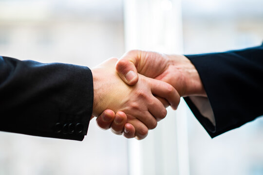 Closeup image of a firm handshake standing for a trusted partnership