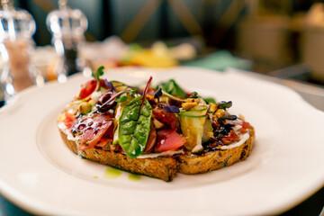 Close-up of bruschetta with jamon and cream cheese cooked in the professional kitchen of an Italian restaurant 
