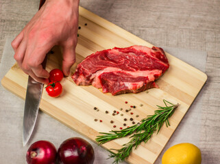 Meat on the table male chef's hand cherry tomato top view cooking kitchen recipes