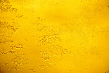 Artificial Gold background and texture on cement make from color paint for look like real gold. Gold foil leaf dirty abstract background texture distress scratch and gradients shadow in Gold glitter
