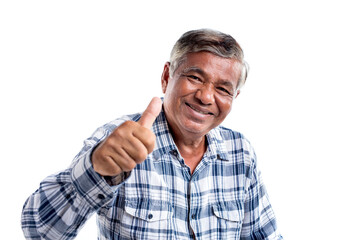 Cheerful elderly Asian man smiling giving a thumb up and looking at the camera, isolated on white...