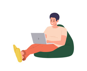 Young man freelancer or student sitting on soft bean bag with laptop computer isolated on white