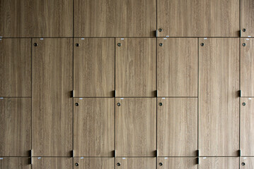 Wooden lockers with key in locker room at school sport club office.