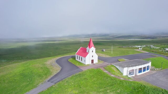 Beautiful holy Ingjaldsholl church on hill in foggy during summer at Snaefellsnes, Iceland