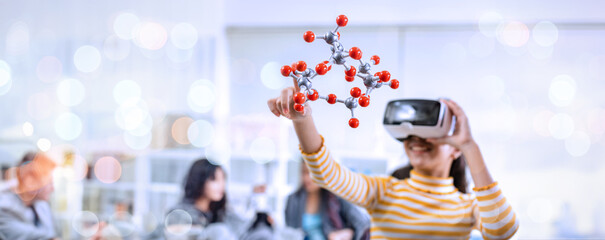 Girl using VR glasses learning molecular model chemistry science at home. Child Wearing Augmented Reality Headset and Using Controllers Interacts with 3D Molecule.