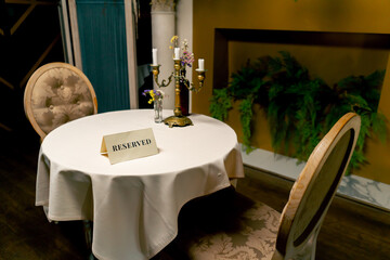Close-up of a reservation sign reserved  standing on a table in an expensive luxury Italian...
