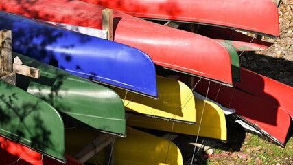 Colorful kayaks hanging upside down