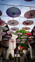 In a small town in Hangzhou, China, colorful umbrellas line the streets