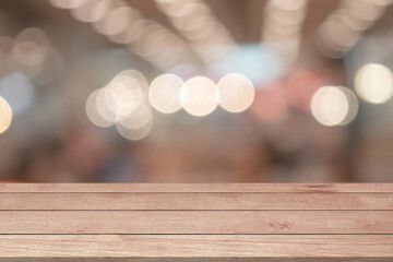 Empty wooden table top or counter on light blur bokeh glowing bright defocused lights template mock...