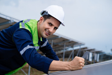 Electrician inspects and maintains equipment in a solar power plant. Professional engineer ideas for photovoltaic power plants
