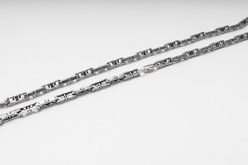 Silver chain on white background, subject macro photography