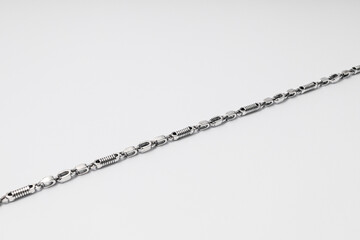 Unusually shaped silver chain on white background, jewelry