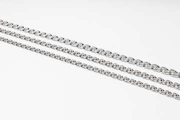 Silver chain on white background, subject macro photography