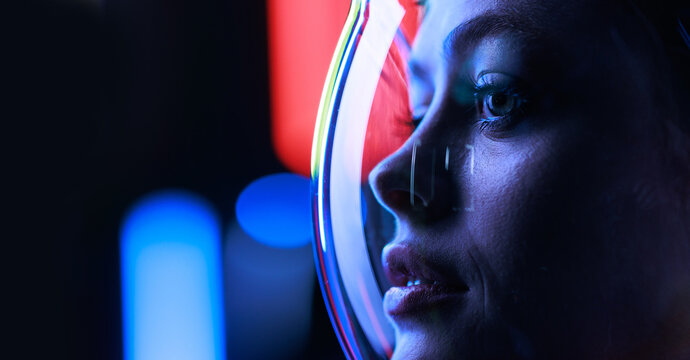 Astronaut in futuristic costume. Girl in glasses of virtual reality while touching air. Augmented reality game, future technology, AI concept. Dark background.