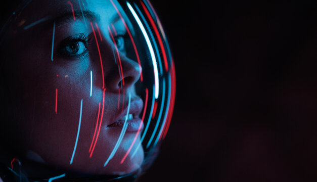 Astronaut in futuristic costume. Girl in glasses of virtual reality while touching air. Augmented reality game, future technology, AI concept. Dark background.