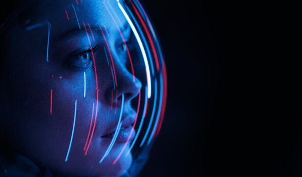 Astronaut in futuristic costume. Girl in glasses of virtual reality while touching air. Augmented reality game, future technology, AI concept. Dark background. - Powered by Adobe