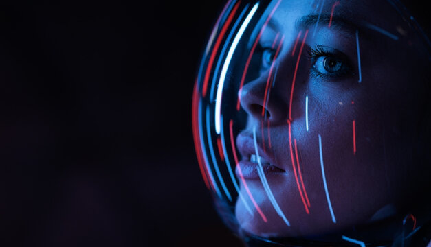 Astronaut in futuristic costume. Girl in glasses of virtual reality while touching air. Augmented reality game, future technology, AI concept. Dark background.