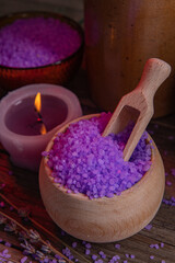Lavender salt and scented candle for the bathroom, for spa and relaxation in a rural cottage interior.