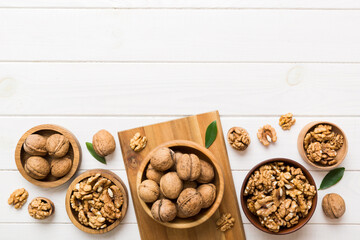 Walnut kernel halves, in a wooden bowl. Close-up, from above on colored background. Healthy eating Walnut concept. Super foods with copy space