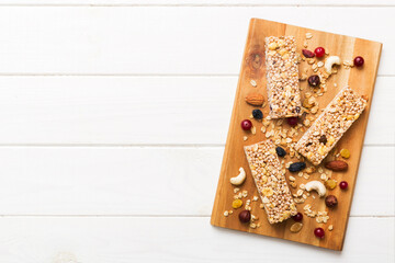 Various granola bars on table background. Cereal granola bars. Superfood breakfast bars with oats, nuts and berries, close up. Superfood concept