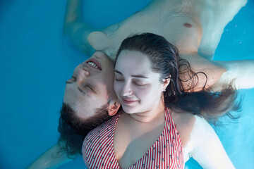 Portraits of a couple in love close-up in a therapeutic spa pool bath relaxing in salty sea water.