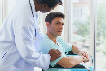Doctor helping patients learn to walking training. A general doctor performs a physical...